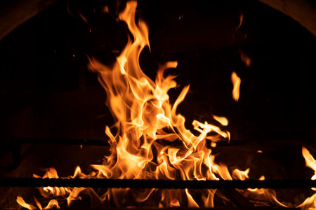 Fire flame in the fireplace. Tongues of flame on a black background. high quality photoの写真素材