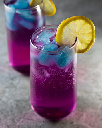Bright refreshing cocktail. Pink lemonade with blue ice cubes. Galaxy lemonade. high quality photoの写真素材