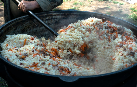Cooking Uzbek pilaf on a fire. high quality photoの写真素材