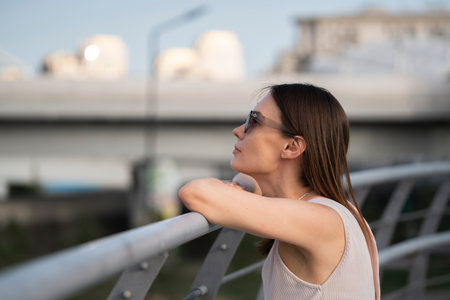 Urban summer portrait of young brunette woman. The woman thought about something. high quality photoの写真素材