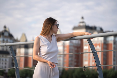 Urban summer portrait of young brunette woman. The woman thought about something. high quality photoの写真素材