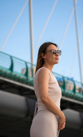 Summer portrait of young brunette woman with sunglasses on blue sky background. high quality photoの写真素材