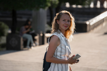 Urban summer portrait of a young blonde woman outdoors. high quality photo