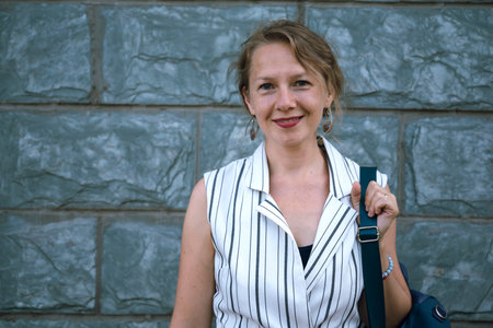 Urban summer portrait of a young blonde woman outdoors. high quality photoの写真素材