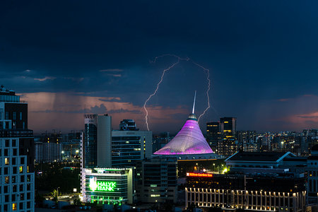 Astana, Kazakhstan, August , 2023. Night view of the Khan Shatyr shopping center during a thunderstorm with lightning. high quality photoの写真素材