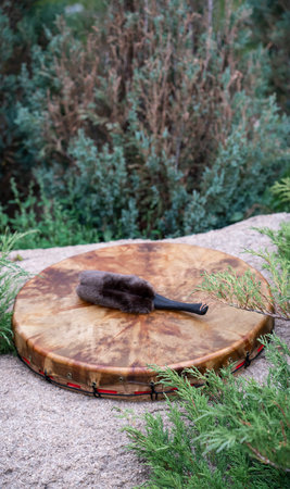 A shaman's tambourine made of leather lies on a stone genuine. High quality photoの写真素材