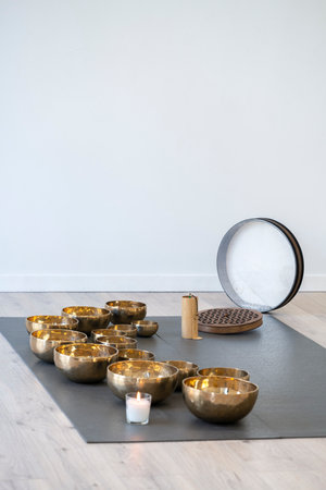 Tibetan singing bowls on the floor in a yoga studio.の写真素材