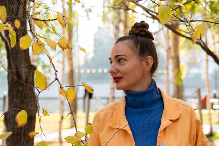 Young woman walking in the park in autumn. High quality photoの写真素材