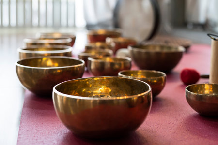 A set of Tibetan singing bowls on the floor of a yoga studio.の写真素材