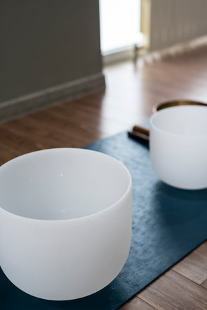 Crystal quartz singing bowls on the floor of a yoga studio.の写真素材