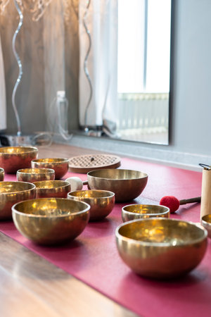 A set of Tibetan singing bowls on the floor of a yoga studio.の写真素材