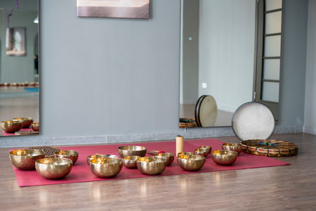 A set of Tibetan singing bowls on the floor of a yoga studio.の写真素材