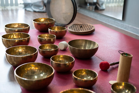 A set of Tibetan singing bowls on the floor of a yoga studio.の写真素材