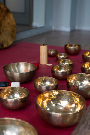 A set of Tibetan singing bowls on the floor of a yoga studio.の写真素材