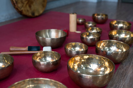 A set of Tibetan singing bowls on the floor of a yoga studio.の写真素材