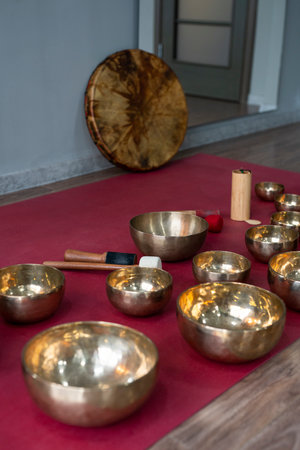 A set of Tibetan singing bowls on the floor of a yoga studio. High quality photoの写真素材