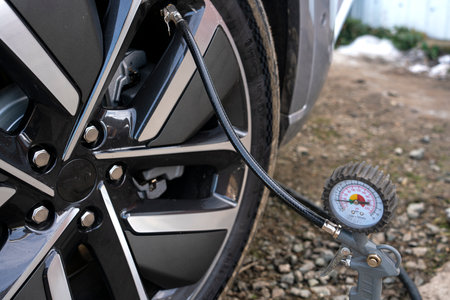 Hand car mechanic holding car tire pressure check equipment tool to checking low tire pressure. High quality photoの写真素材