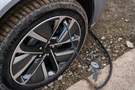 Hand car mechanic holding car tire pressure check equipment tool to checking low tire pressure. High quality photoの写真素材