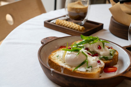 Brioche with poached egg for breakfast. High quality photoの写真素材