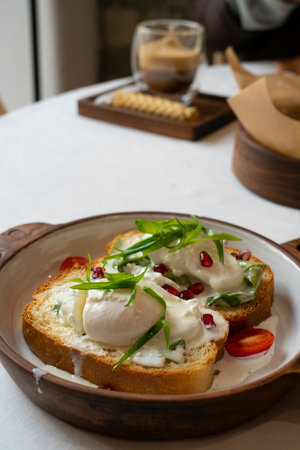 Brioche with poached egg for breakfast. High quality photoの写真素材