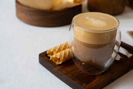 Latte in a transparent glass on a table in a cafe. High quality photoの写真素材