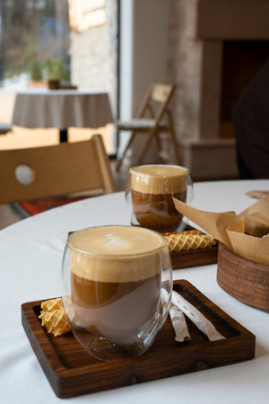 Latte in a transparent glass on a table in a cafe. High quality photoの写真素材