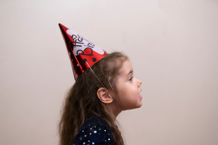 Four-year-old girl in a cap for her birthdayの素材