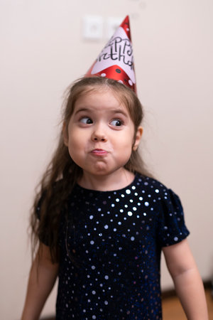 Four-year-old girl in a cap for her birthdayの素材