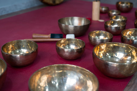A set of Tibetan singing bowls on the floor of a yoga studio.