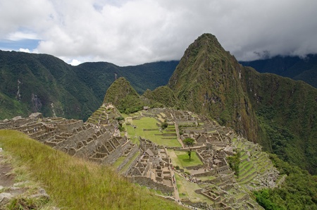 The ruins of the Inca Site Machu Picchu, a UNESCO World Heritage Site and one of the New Seven Wonders of the World  In the background the mountain Huayna Picchuの写真素材