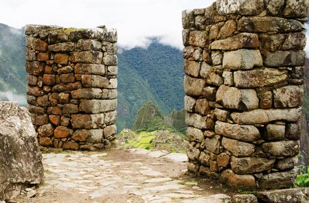 At the halfway point between Machu Picchu and Intipunku, Peru with the ruins of ancient Inca village of Machu Picchu in the backgroundの写真素材