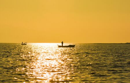 Fishing boat on the sea at sunset.の写真素材