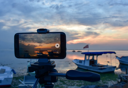 Telephone camera while taking the beautiful cloudy sunset scene.