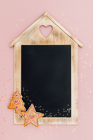 Christmas chalkboard, with star and christmas tree decorations and golden star-shaped glitter. Vintage style. Top view. With space for text.の写真素材