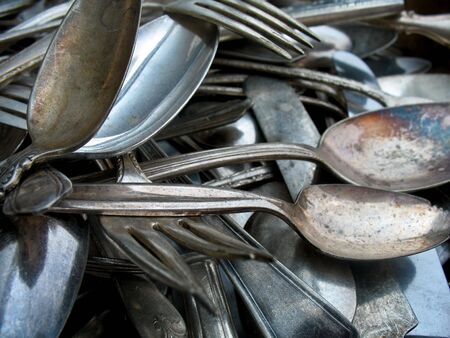 Antique silverware (or cutlery) in a pileの写真素材