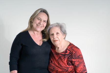 Woman and her elderly mother side by side. Isolated.の写真素材