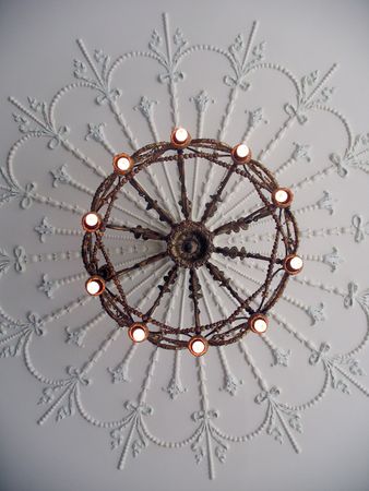 A shot of an antique chandelier, shot looking straight up.