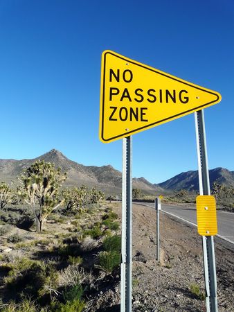 Close-up of road sign posted along street. Vertically framed shot.の写真素材