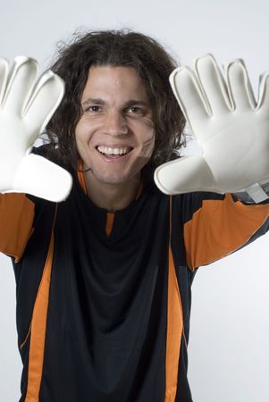 Soccer goalie smiles as he holds his hands up.  Vertically framed photographの写真素材