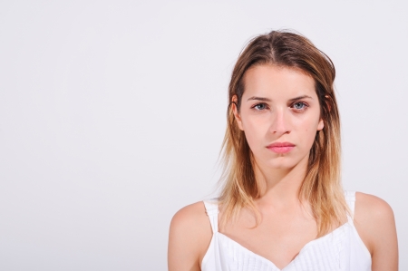 Closeup with copy space and white of a young girl with serious expression and determinedの写真素材