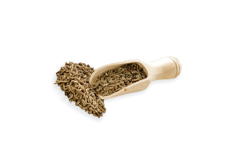 Food ingredients heap of cumin in a wooden scoop, on white background