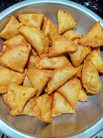 Samosa or samosas (samsa) street food, punjabi samosa or Coxinha, Croquete and other Fried Brazilian...