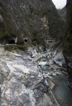 This is Taroko Gorge, Taiwan's number one tourist site.  It's a dramatic gorge that cuts through high mountains.  Here is the river that cuts through it, together with a road and many tunnels.  In some places the cliffs are over 600m highの写真素材