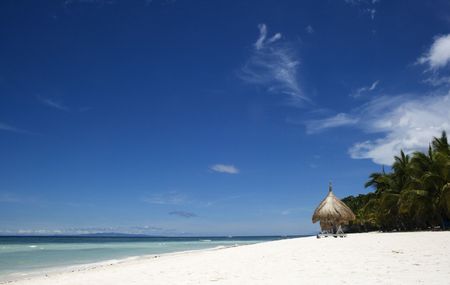 Whites sands, blue skies and beach huts.  This is a tropical resort, the perfect vacation spotの写真素材