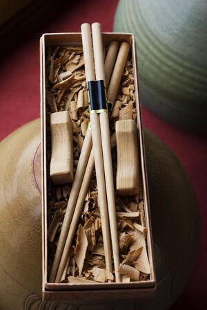 Handmade chopsticks presented in a gift books.  They are made from wood and are an essential symbol of chinese culture.の写真素材