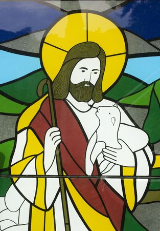 Stained glass image of Jesus with a lamb.  Like a sheppard taking care of his flock.の写真素材