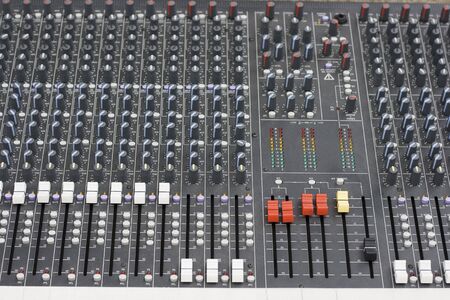 Close up of a sound mixer being operated.  The machine has been checked for brand names and logo and have been removed.の写真素材