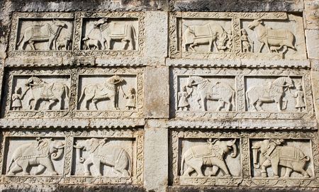 A carving in stone of elephants, cows and horses.  This was taken at an Indian palace and probably depicts the role of animals in royal India.の写真素材