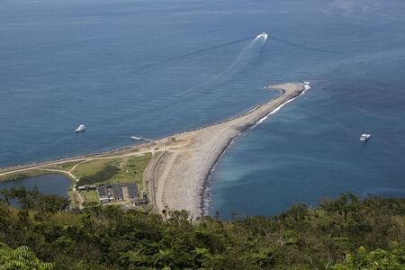 A sea spit of the coast of turtle island, Taiwan. This is one is called the turtle tail because of the  curl at the end of it.の写真素材