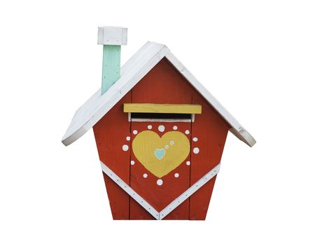 A mail box in the shape of a house has been isolated from its background.の写真素材